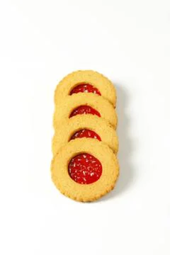 Three jam-filled round cookies on plain background Stock Photos