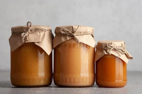 Three jars of apple jam on gray background Stock Photos