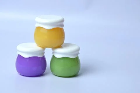 Three jars for cream on a blue background. Stock Photos