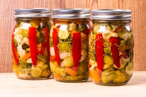 Three jars of preserved mixed vegetables Stock Photos