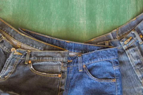 Three of jeans with chalkboard background Stock Photos