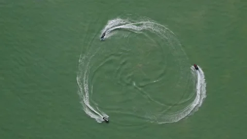 Three Jet Ski Sea-Doos make Circle Pattern on Lake Water Surface, Aerial Stock Footage 197641571