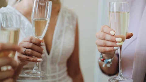 Three joyous young girlfriends with champagne glasses in their hands close-up Stock Footage 123723051