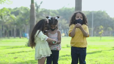 Three Kid Friends In Protective Face Mask And Sanitizing Their Hands 스톡 동영상 239322242