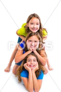 Three kid girls friends happy stacked in a row Stock Photos