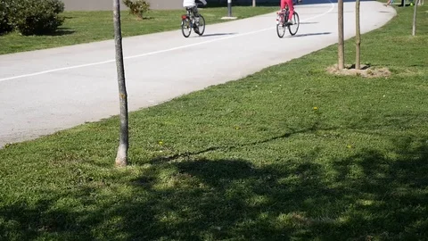 Three kids on bikes passing by Stock Footage 88597979