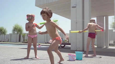 Three kids having fun on the swimingpool Stock Footage 65215113
