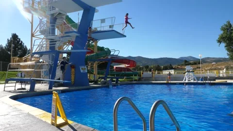 Three kids jumping into a pool together.  Stock-Footage 151378382