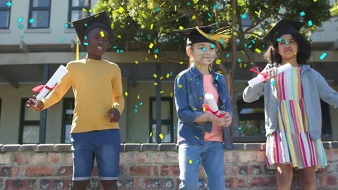 Three kids standing on low wall outside confetti starting graduating exchanging 스톡 동영상 333368292