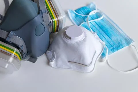 Three kind of protective face masks on gray background. Different types of pr Stock Photos