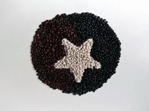 Three kinds of beans are spread out on the surface in the form of a flat circ Stock Photos