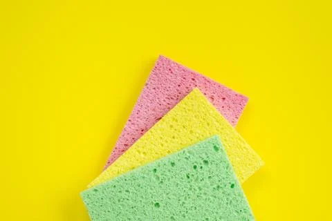 Three kitchen rag lying on yellow background. Top view Stock Photos