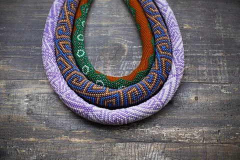 Three knitted beaded plaits Stock Photos