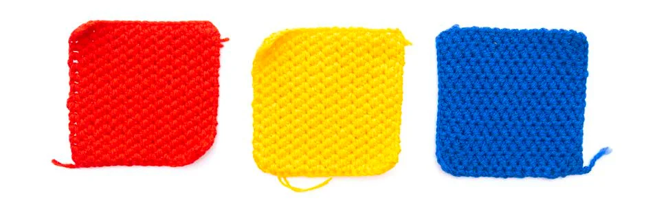 Three knitted patch squares: red, yellow, blue isolated on white background 스톡 사진