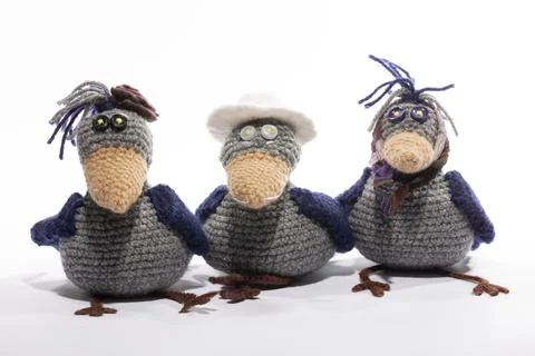 Three knitted wool crows on a white background Stock Photos