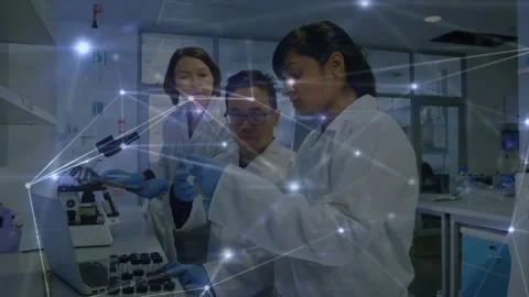 Three lab scientists handling vials, camera focus sparking network overlay Stock Footage 330577869
