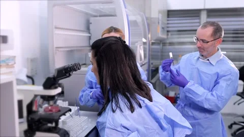 Three lab workers are doing research work at the laboratory Stock Footage 233345704