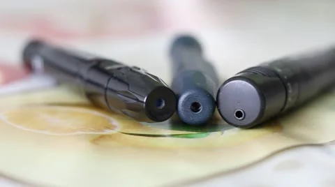 Three Lancing Devices used by Diabetes Lying on a Table Stock Footage 67471751