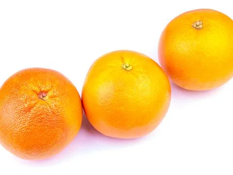 Three large grapefruits on a table Stock Photos