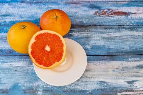 Three large grapefruits on a table Stock Photos