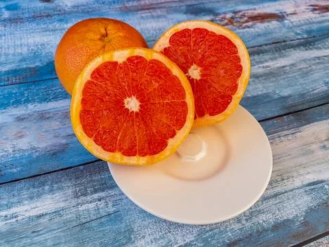 Three large grapefruits on a table Stock Photos