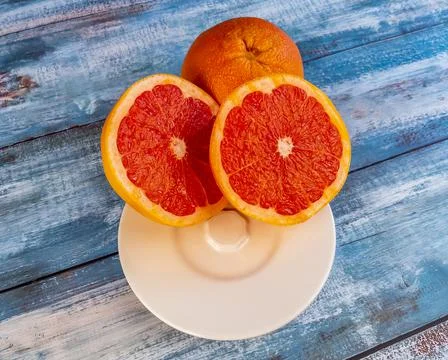 Three large grapefruits on a table Stock Photos