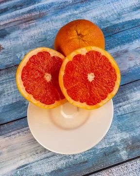 Three large grapefruits on a table Stock Photos
