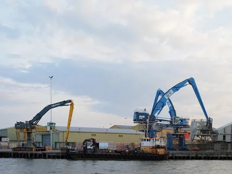 Three large mobile cranes on the dockside at Poole Quay in Dorset Stock Photos