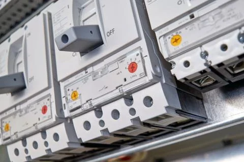 Three large, modern, powerful circuit breakers in the electrical Cabinet. Stock Photos