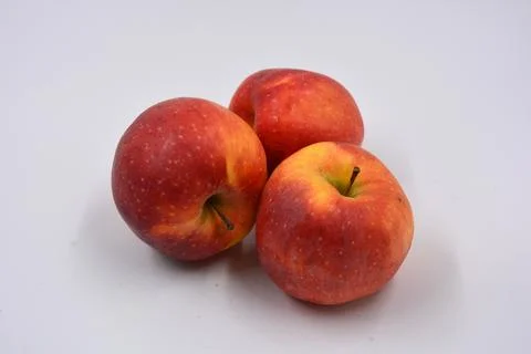 Three large ripe red yellow apples, sweet fruits arranged on a white background. Stock-Fotos
