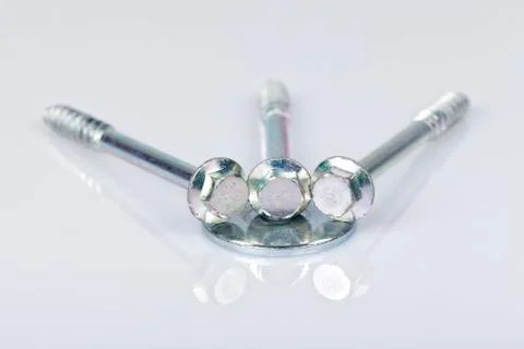 Three large screws used in the construction industry isolated Stock Photos