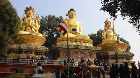 Three large statues of Buddhas and visitors Stock Footage 59182650