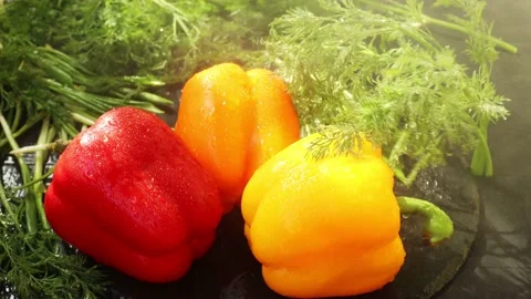 Three large sweet peppers, red, orange and yellow, dill Stock Footage 237307170