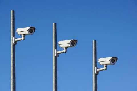 Three Laterally camera on a post in bue sky Stock Photos