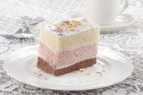 Three layer cake with coloured sprinkle Stock Photos
