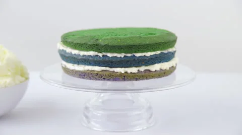 Three layer cake on plate with cream between 4K Video stock 64979354