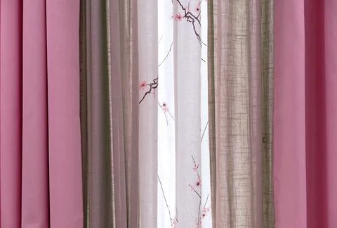 Three-layer curtains in pink, beige and white fabric. Stock Photos