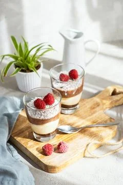 Three-layer mousse dessert made of chocolate and vanilla, decorated with fresh Stock Photos