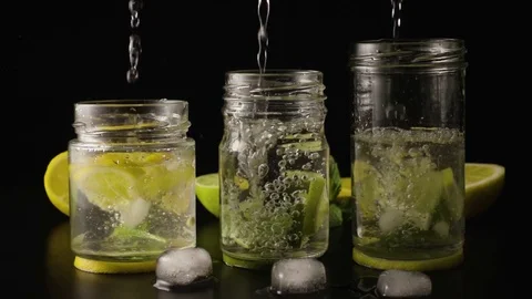 Three lemonade in jars super slow motion Stock Footage 72945365