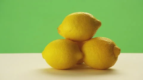 Three lemons for lemonade shot against greenscreen Stock Footage 146364968