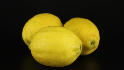 Three lemons rotates on a black background. Close-up video vitamin. Stock-Footage 151987516
