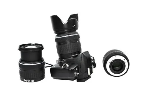Three lens of a digital camera while one is attached to it placed beside one Stock Photos