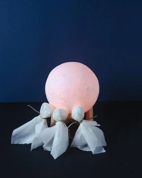 Three levitating ghosts in over the moon on dark background Stock Photos