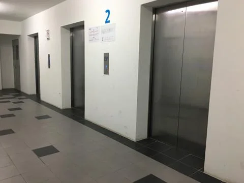 Three lifts inside the building. Stock Photos