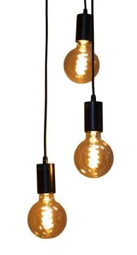 Three light bulbs hang down from black cords. The bulbs are lit and give off  Stock Photos