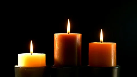 Three lighted candles spinning on the central candle. Stock Footage 126646119