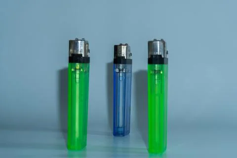 Three lighters stand upright, one green, one blue, one green Fotos de archivo