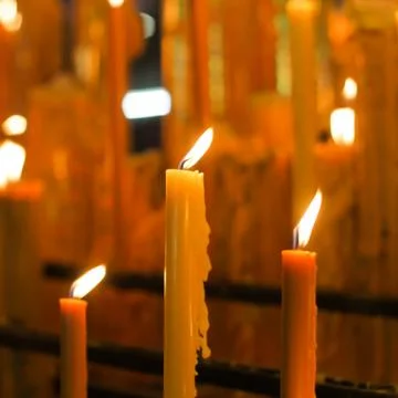 Three lit candles Stock Photos