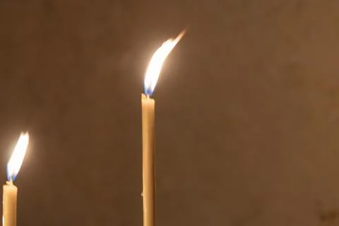 Three lit candles, warm light, similar height, possibly from a set, natural.. Photos