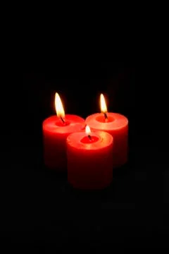 Three lit red candles Stock Photos
